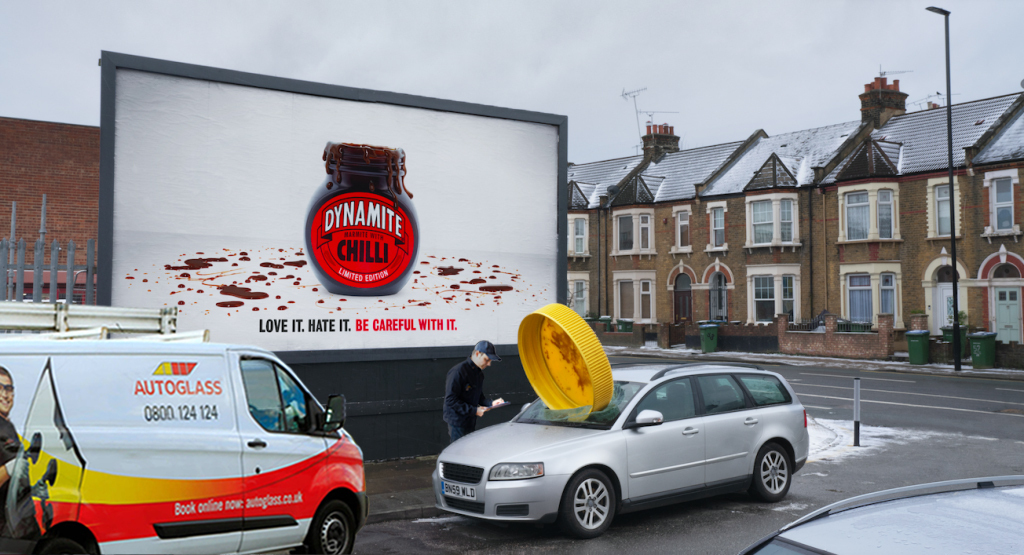 Giant Marmite lid smashed through a car window with Autoglass van fixing it.